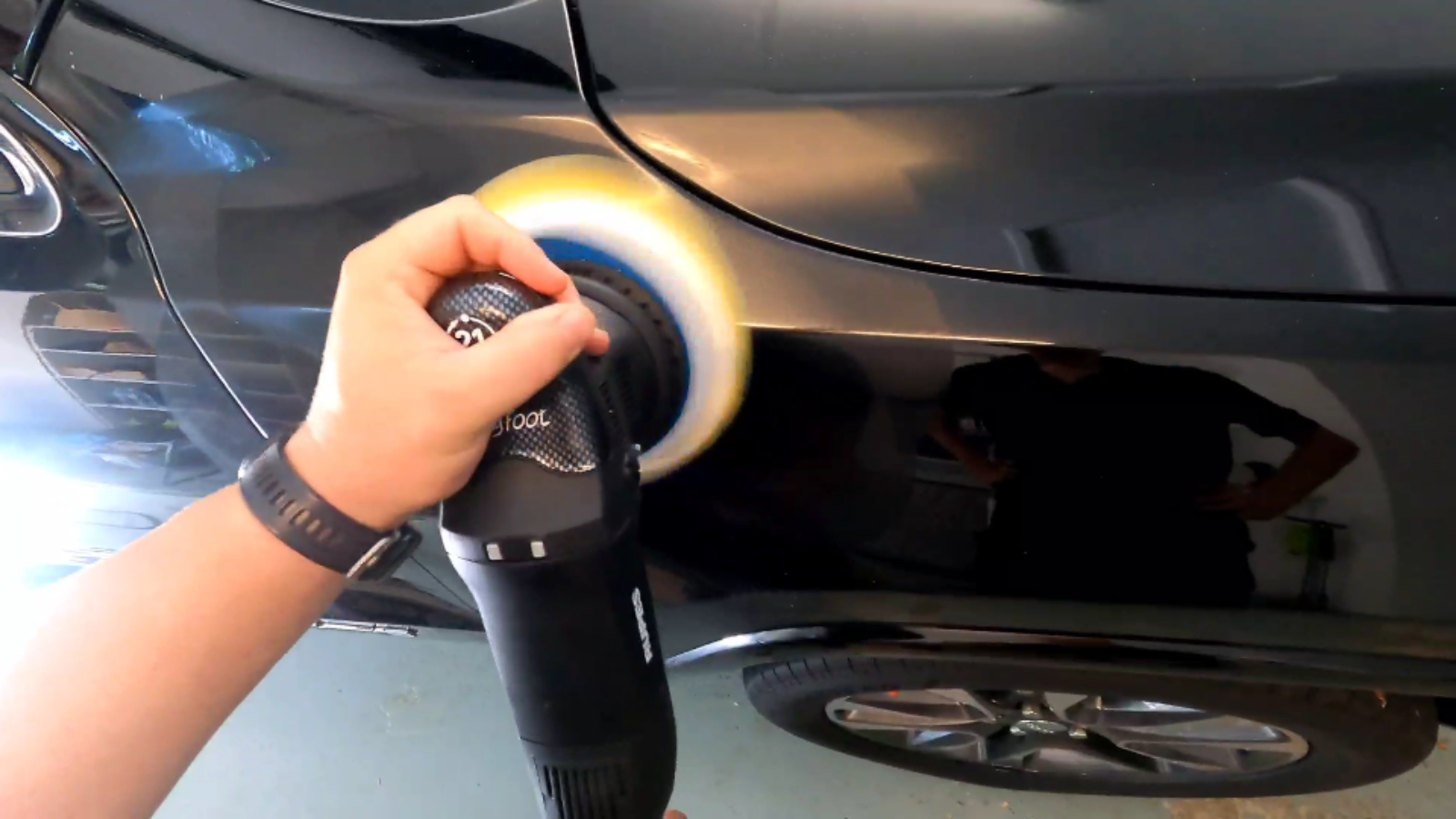 picture of a car detailing technician performing a paint correction